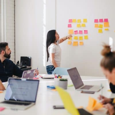 A woman showing her team the progress of a project